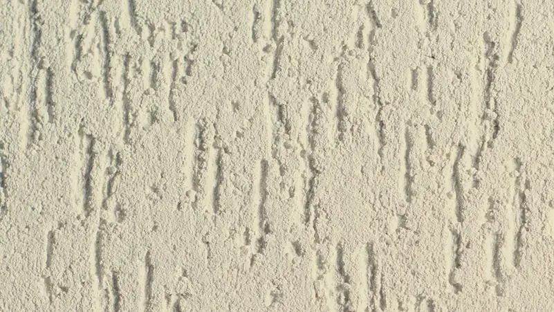 Max Coat stucco finish — close-up of the texture on a sample board