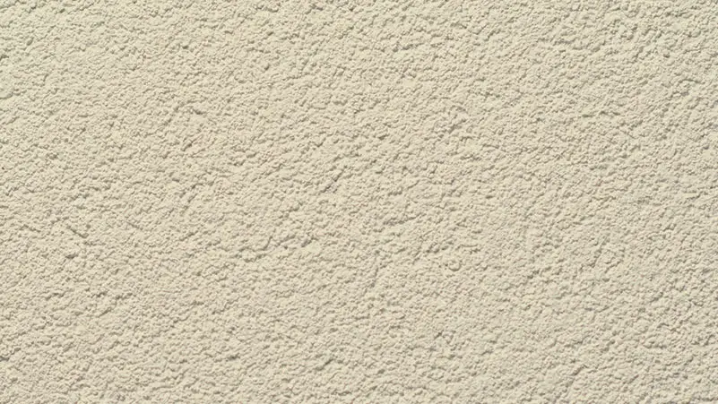 Pebble Coat stucco finish — close-up of the texture on a sample board