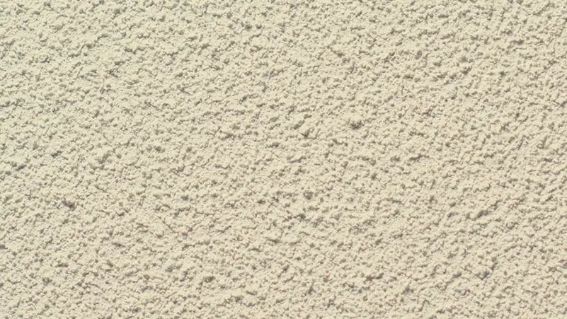 Pebble Spray stucco finish — close-up of the texture on a sample board