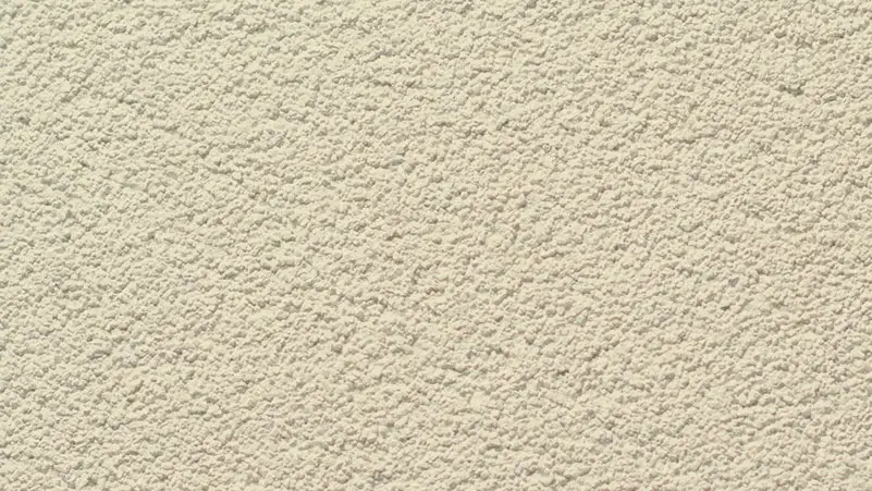 Sand Coat stucco finish — close-up of the texture on a sample board
